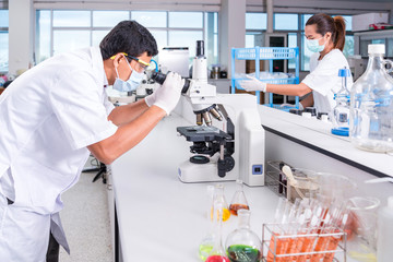 scientists male and female with equipment and science experiment