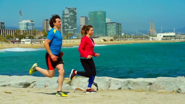 Couple running next to the navy blye sea, steadycam shot, slow motion shot
