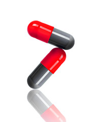 close-up of two medical capsules isolated on white background