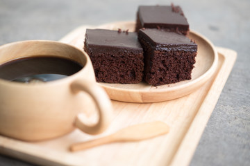 Square piece of chocolate cake with cream filling