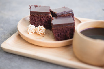 Square piece of chocolate cake with cream filling