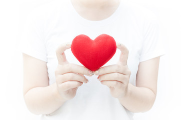 Woman holding and protecting a red heart shape on white background close-up,Symbol of love or dating Valentines day