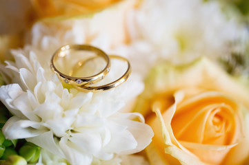 Wedding rings with rose flowers, selective focus