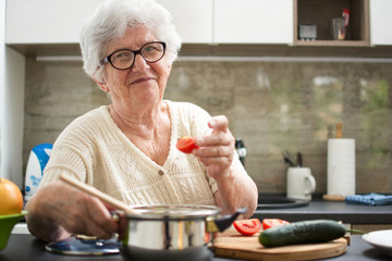 Senior woman cooking in the kitchen.