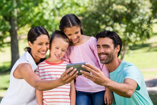 Happy family taking selfie from mobile phone