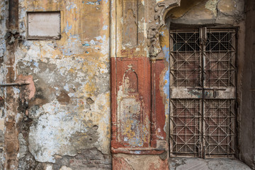 Gated door way in dilapidated wall in Delhi
