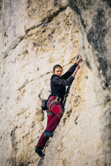 women climbs a rock