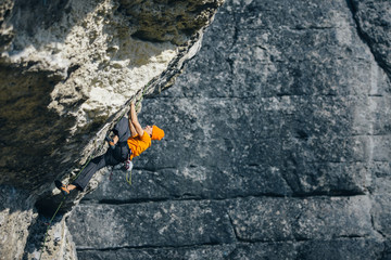 men climbs a rock