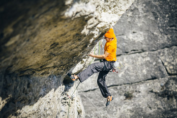 men climbs a rock