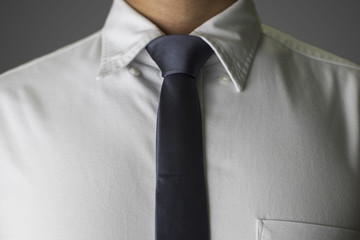 Closeup on a grey skinny necktie on an Asian man