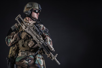 United states Marine Corps special operations command Marsoc raider with weapon. Studio shot of...