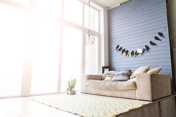 room type loft and sofa stands near a large window