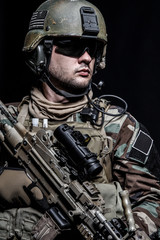United states Marine Corps special operations command Marsoc raider with weapon. Studio shot of...