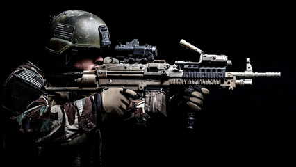 United states Marine Corps special operations command Marsoc raider with machine gun. Studio shot of Marine Special Operator black background © Getmilitaryphotos
