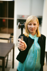 blonde woman in the kitchen, holding a cutlery