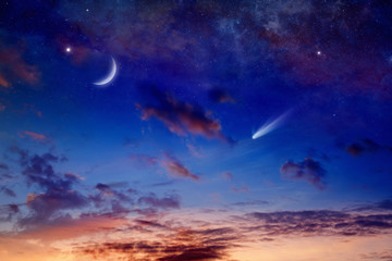 Bright comet, falling star and crescent in glowing sunset sky. Elements of this image furnished by...