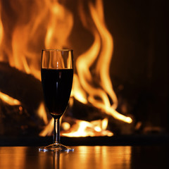 glasses of red champagne  by the fireplace