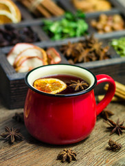 wooden box with nuts, spices and dried fruits, mint on wooden background