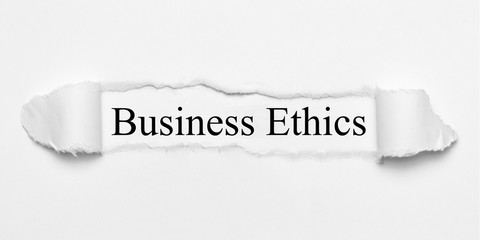Business Ethics on white torn paper
