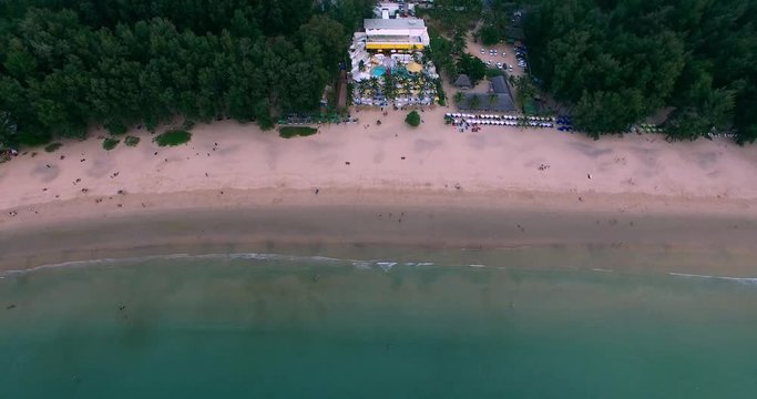 Aerial footage. Flying close over tropical sandy beach and waves. Thailand. Phuket. Layan beach. 4K