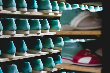 Storage room with slippers shoes on shelves in family run firm