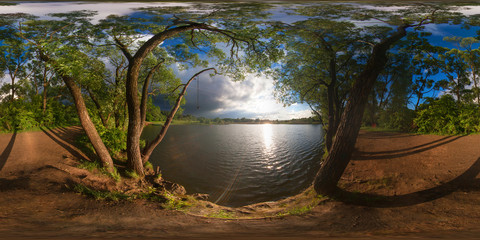 Full 360 degree equirectangula panorama forest lake at sunset