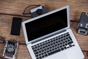 Close-up of laptop with cameras on table