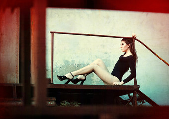 Outdoor fashion shot: beautiful young girl in black body. Grunge and glitch effects