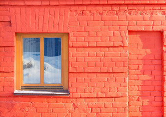 The window on the wall of red brick