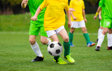 Running Football Soccer Players with Ball. Footballers Kicking Football Match on the Pitch. Young Teen Soccer Game. Youth Sport Background