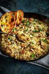 Mushroom Risotto in iron pan with herbs and parmesan cheese