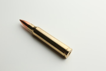 Rifle bullet on white background
