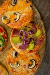 Various types of pizza arranged on a wooden tray