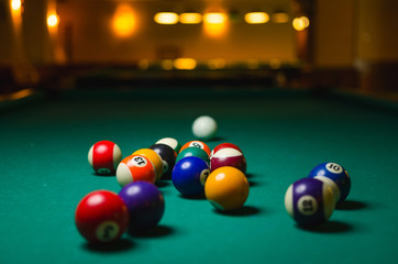 Billiard balls on green table.