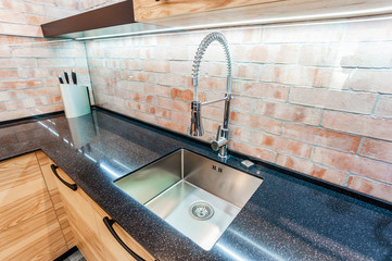 Modern kitchen. Sink and chrome faucet