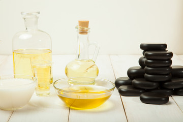 Massage oil on a white wooden background