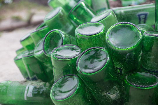 Pile Of Empty Green Beer Bottles Thrown Away On A Beach Illustrate Environment Pollution