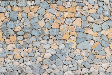 Background stone wall texture. Dry wall with stones arranged irregularly   