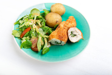 Kiev cutlet with jacket potatoes and salad