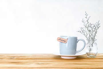 Coffee cup mug with happy word tag on wooden table , Romance and