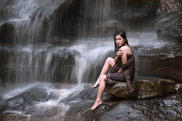 Fototapeta na wymiar Asian sexy woman bathing in cascade Thailand