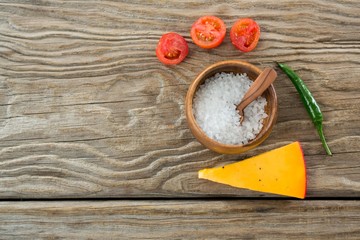 Tomatoes, cheese, chilli with salt on a bowl