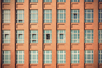 Fototapeta premium Old red brick industry building facade, vintage filtered style