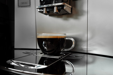 coffee in a glass cup on a modern coffee machine