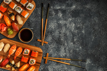 Fototapeta na wymiar Sushi Set: sushi and sushi rolls on wooden plate.