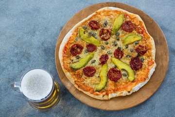 Italian pizza served with a mug of beer