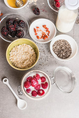 Healthy breakfast  in glass with oatmeal , Chia seeds, Goji berries, fresh berries and yogurt, top view