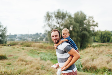 Fototapeta premium Father and son in nature in summer park