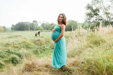 Pregnant woman walking in park