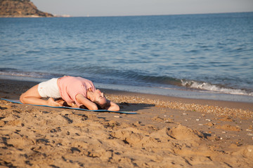 girl doing gymnastics in the morning on the Beach Ocean